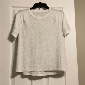 A grey and white short-sleeve see-through top